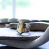 brass and silver mjolnir ring