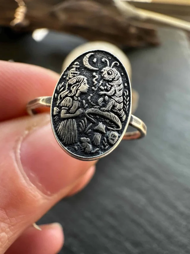 There's no assembly line. No mass production. Just me at my bench, handcrafting to order in small batches in my home studio.

These Alice in Wonderland rings are a perfect example. Every tiny detail in the Caterpillar scene and the Red Queen... engraved and soldered by hand, one piece at a time.

...Which scene from Wonderland is your favorite? ⬇️

#HandmadeJewelry #Silversmith #AliceInWonderland #StorybookJewelry #ArtisanJewelry #MadeByHand #FairyTaleJewelry #SmallBatchJewelry #HandcraftedSilver #TheWickedGriffin