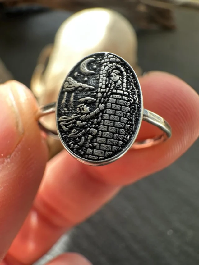 The original Rapunzel story wasn't sweet. A girl locked in a tower, a witch who cut her off from the world, a prince who went blind falling from the window.

But she survived. She found her voice. She healed the prince with her tears.

This ring wraps the tower around your finger. A reminder that the strongest people are the ones who found their way out.

Handcrafted to order in my home studio.

Which fairytale do you think deserves a darker retelling? 🏰👇

#Rapunzel #FairytaleRing #StorybookJewelry #LiteraryJewelry #SterlingSilver #HandmadeJewelry #DarkFairytale #FantasyRing #GothicFairytale #PrincessTower #TheWickedGriffin